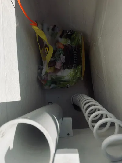 Someday Yacht Photos Pics Interior compartment of 2012 Back Cove 34 boat with storage items and coiled cable.