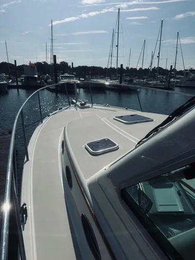 Someday Yacht Photos Pics 2012 Back Cove 34 yacht docked at marina with sailboats in background.
