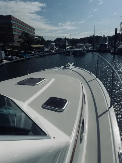 Someday Yacht Photos Pics 2012 Back Cove 34 boat docked in a marina under a partly cloudy sky.
