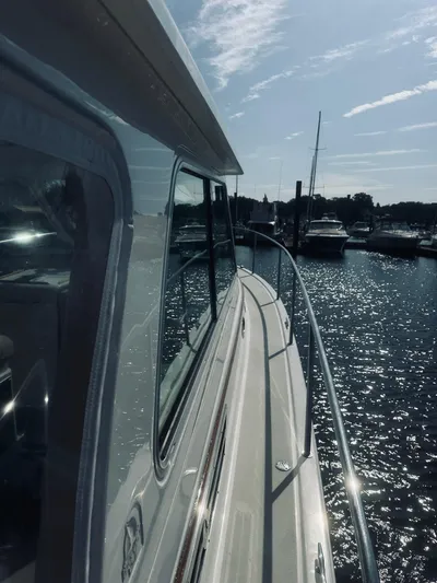 Someday Yacht Photos Pics 2012 Back Cove 34 yacht docked in sunny marina, reflecting on water.