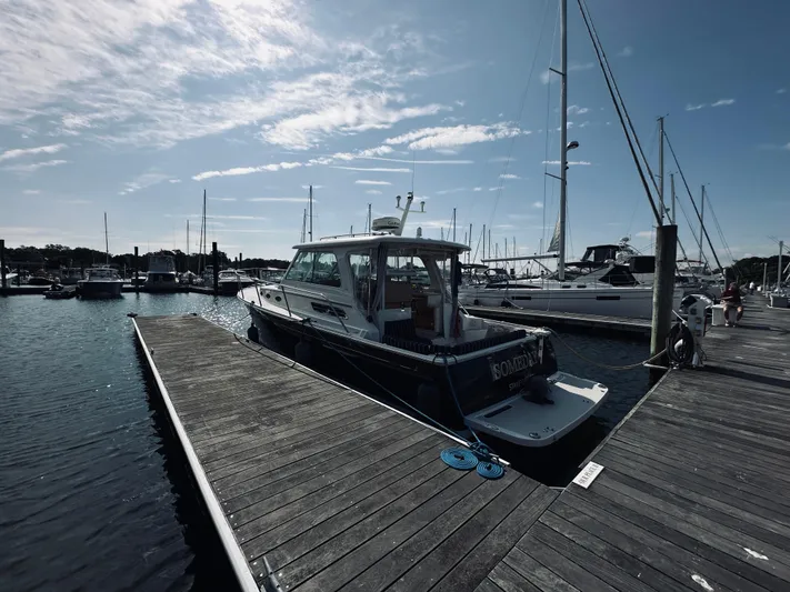 Someday Yacht Photos Pics 2012 Back Cove 34 boat docked at a marina under a partly cloudy sky.