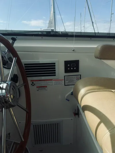 Someday Yacht Photos Pics Interior view of 2012 Back Cove 34 boat cockpit with steering wheel and seating.