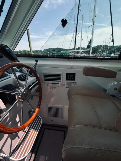 Someday Yacht Photos Pics 2012 Back Cove 34 boat interior with steering wheel and leather seat, marina view.