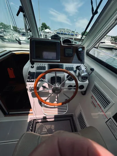 Someday Yacht Photos Pics Interior helm of 2012 Back Cove 34 boat with steering wheel and navigation equipment.