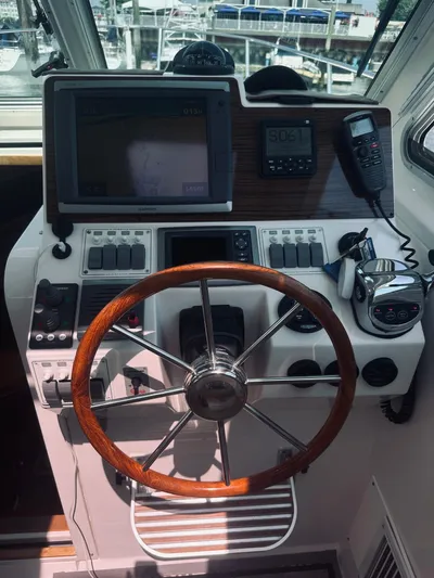 Someday Yacht Photos Pics 2012 Back Cove 34 helm with wooden steering wheel and navigation equipment.