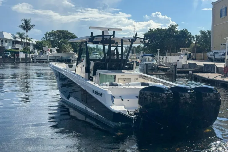  Yacht Photos Pics 2019 Wellcraft 352 Fisherman boat docked in a sunny marina setting.
