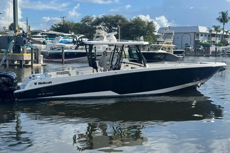  Yacht Photos Pics 2019 Wellcraft 352 Fisherman boat docked in a marina, clear sky background.