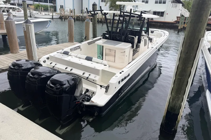  Yacht Photos Pics 2019 Wellcraft 352 Fisherman boat docked with triple outboard engines.