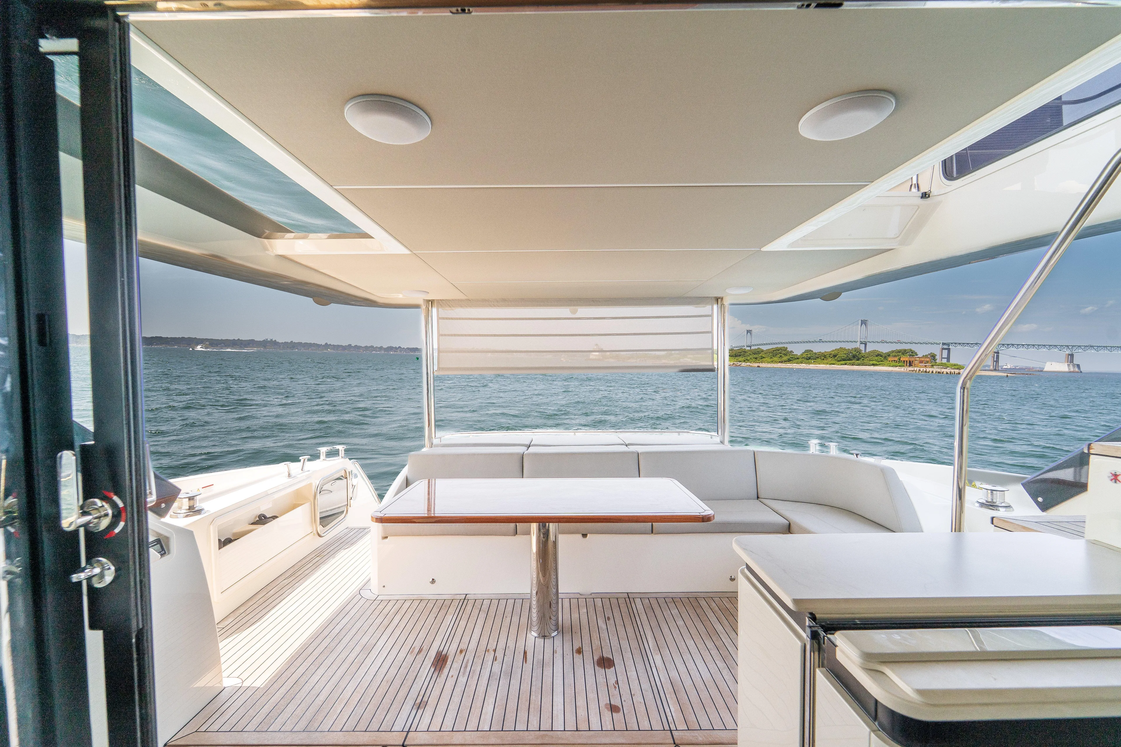  Yacht Photos Pics Luxurious 2023 Absolute 62 Fly yacht interior with ocean view and elegant seating area.