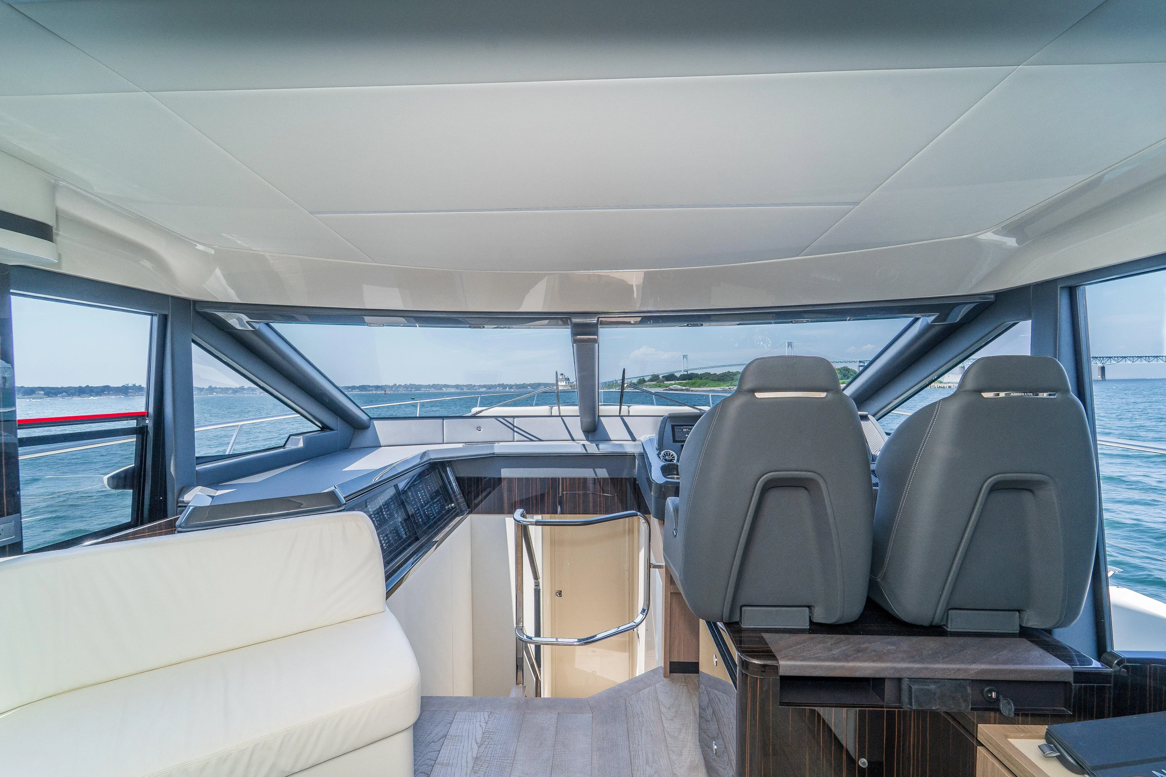  Yacht Photos Pics Interior view of 2023 Absolute 62 Fly yacht cockpit with modern seating and panoramic windows.