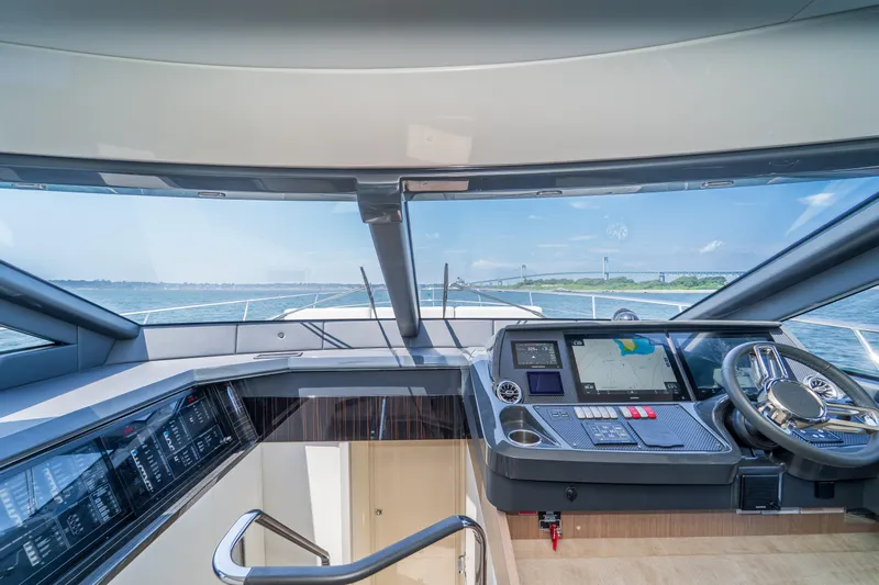  Yacht Photos Pics Cockpit view of 2023 Absolute 62 Fly yacht with navigation screens and steering wheel.