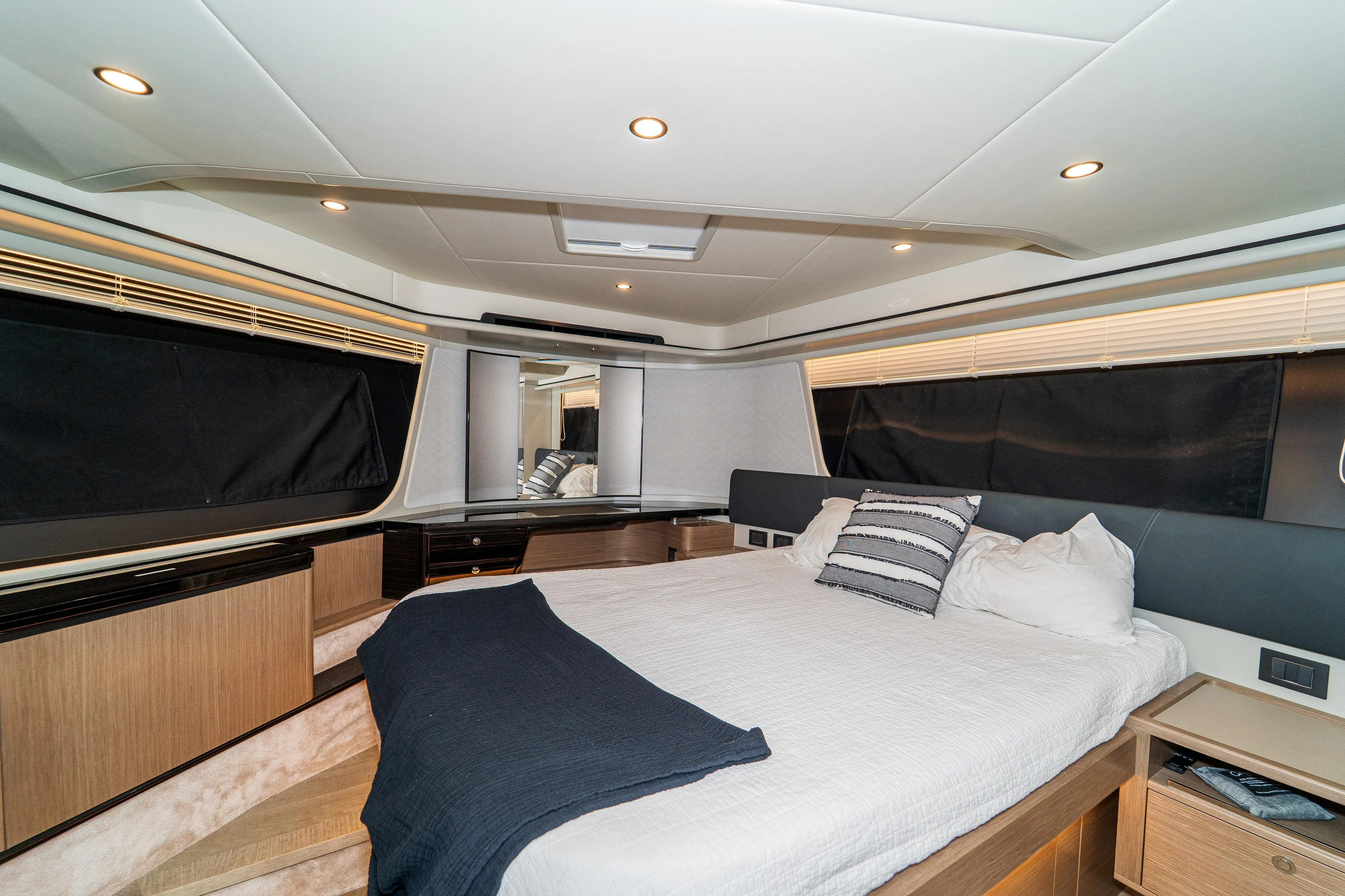  Yacht Photos Pics Luxurious bedroom interior of 2023 Absolute 62 Fly yacht with modern design and cozy bedding.