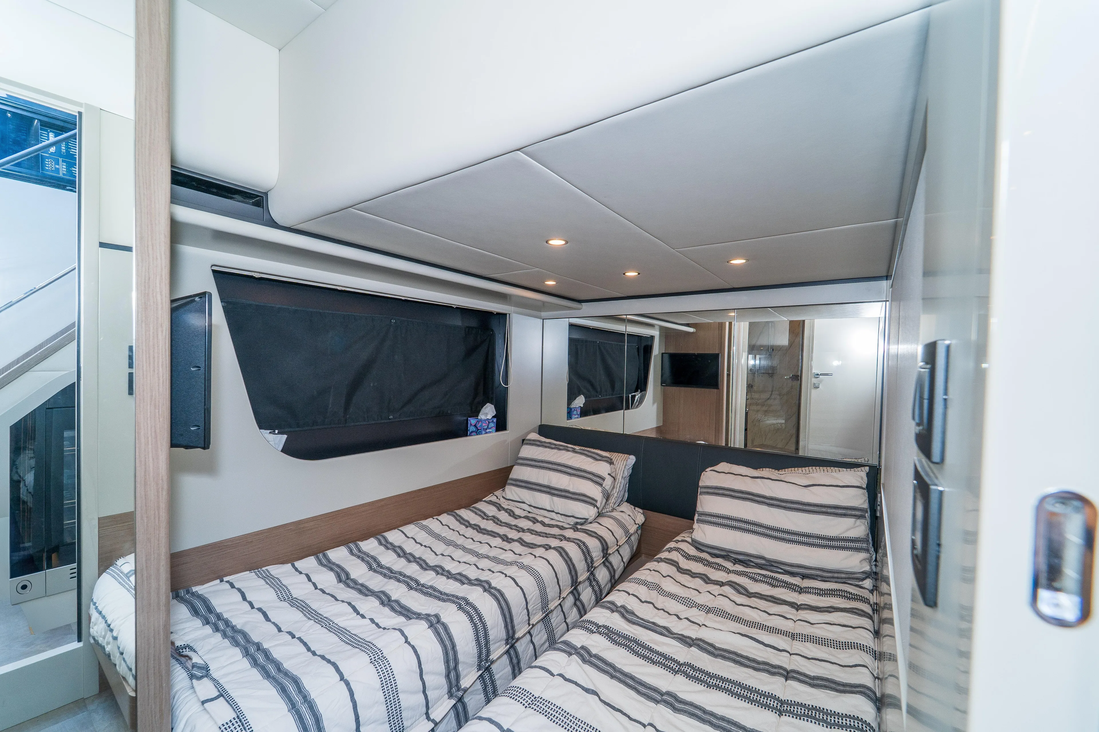  Yacht Photos Pics 2023 Absolute 62 Fly yacht cabin with twin beds and modern interior design.