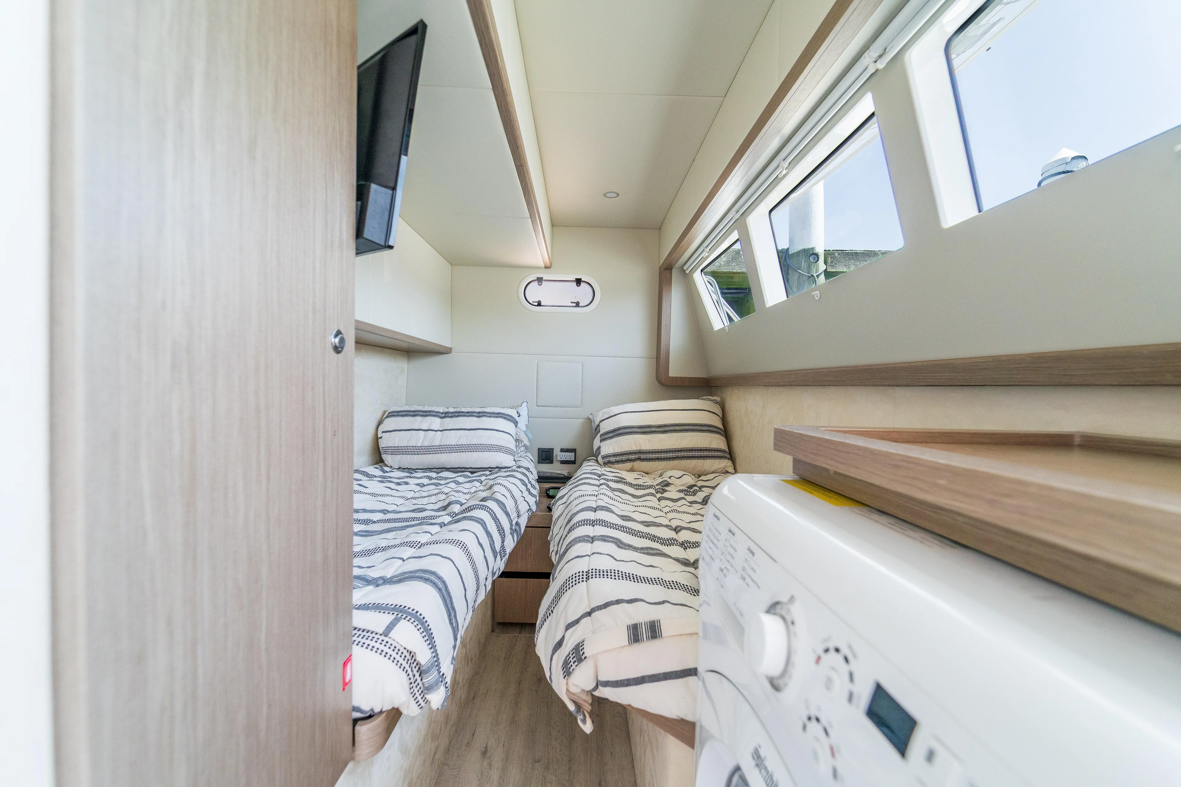  Yacht Photos Pics 2023 Absolute 62 Fly yacht cabin with twin beds and modern amenities.