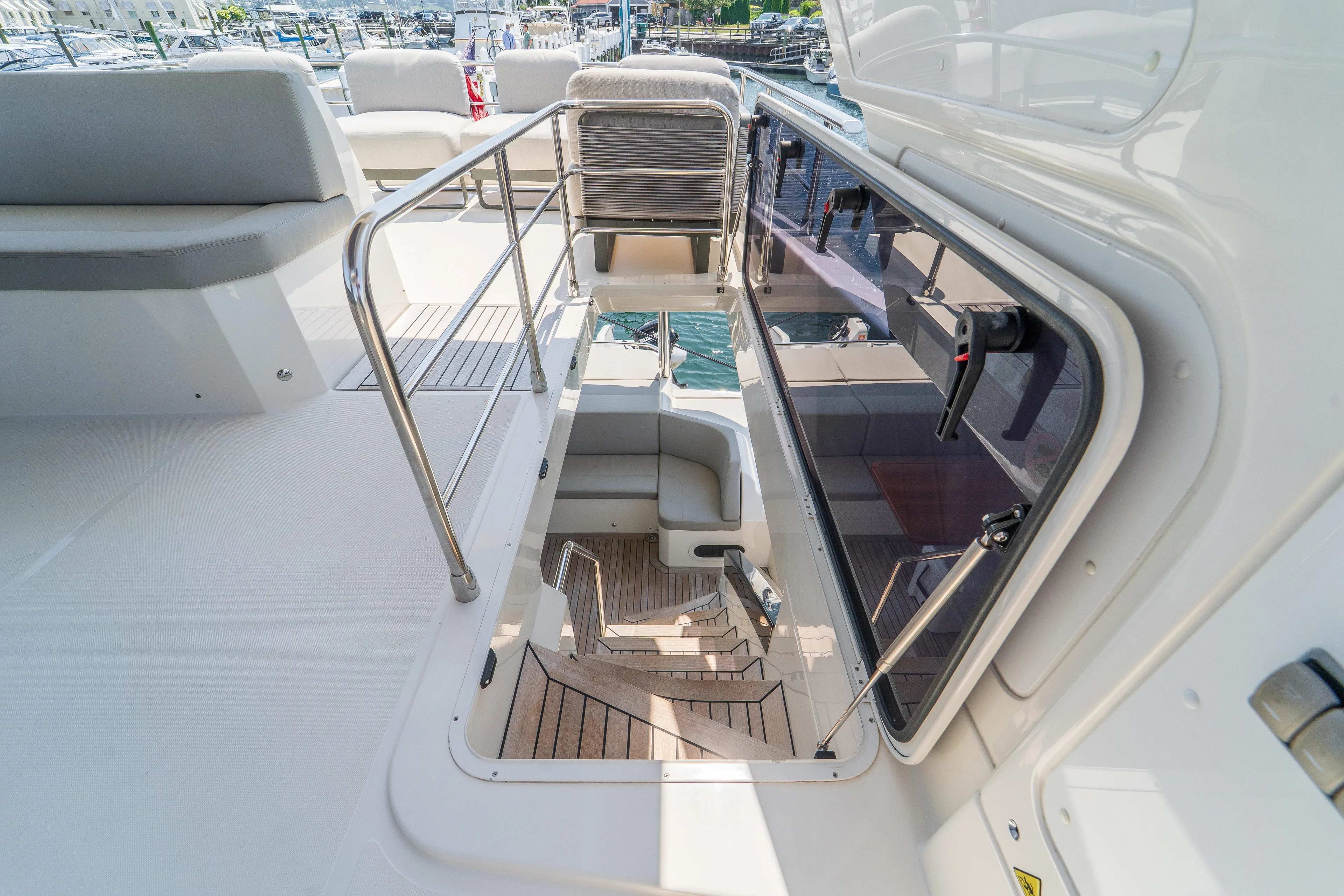  Yacht Photos Pics 2023 Absolute 62 Fly yacht interior with stairs and seating area.