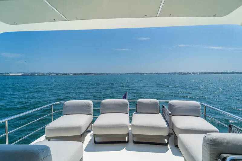  Yacht Photos Pics Luxurious 2023 Absolute 62 Fly yacht deck with sun loungers overlooking the ocean.