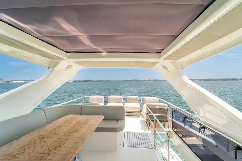 Yacht Photos Pics Luxurious 2023 Absolute 62 Fly yacht with spacious deck and ocean view.