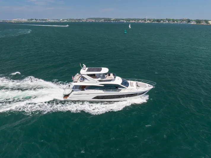  Yacht Photos Pics 2023 Absolute 62 Fly yacht cruising on open water.