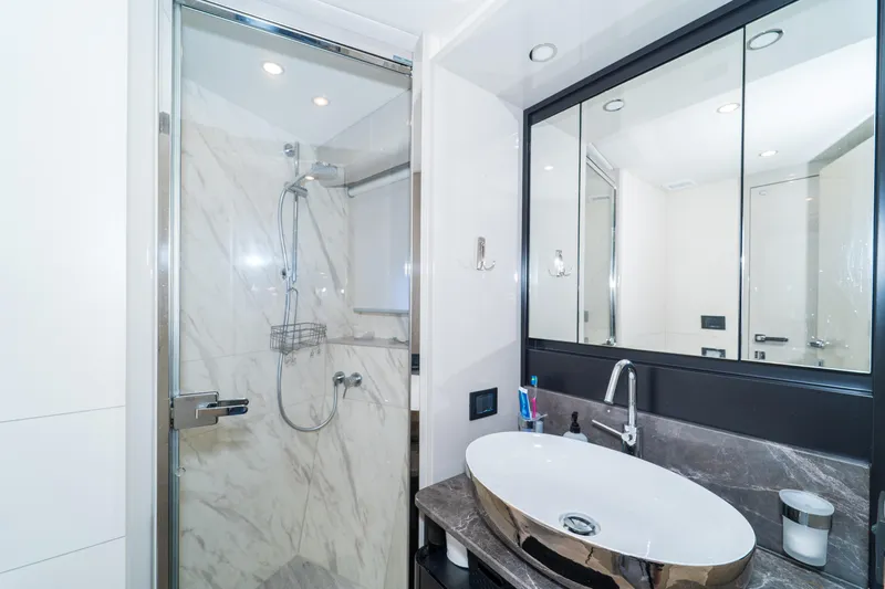  Yacht Photos Pics Luxurious bathroom on 2023 Absolute 62 Fly yacht with modern shower and elegant sink.