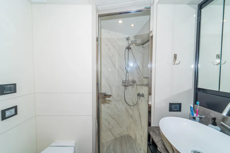  Yacht Photos Pics Modern bathroom on 2023 Absolute 62 Fly yacht with shower and sleek fixtures.