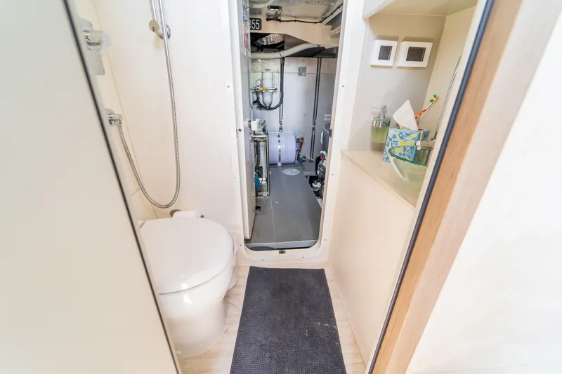  Yacht Photos Pics Bathroom and engine room of 2023 Absolute 62 Fly yacht, featuring modern amenities.