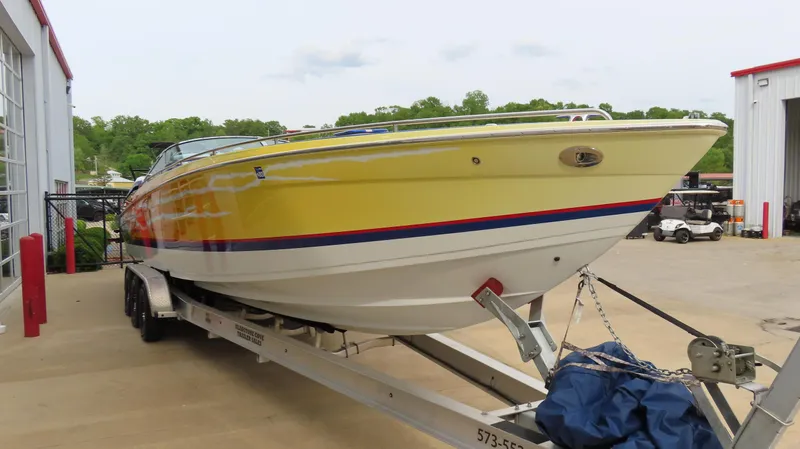  Yacht Photos Pics 2008 Formula 382 FASTech boat on trailer, yellow hull, parked outdoors.