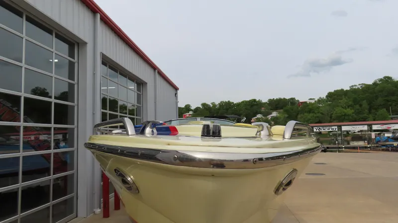  Yacht Photos Pics 2008 Formula 382 FASTech boat docked near a garage, showcasing sleek design and vibrant color.