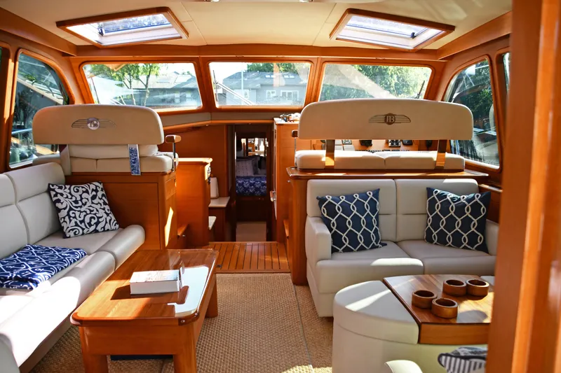 Mack Yacht Photos Pics Luxurious interior of 2020 Palm Beach Motor Yachts PB52 with elegant seating and wooden accents.