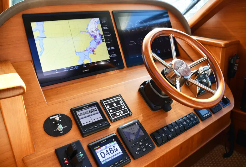 Mack Yacht Photos Pics 2020 Palm Beach Motor Yachts PB52 helm with navigation screens and wooden steering wheel.