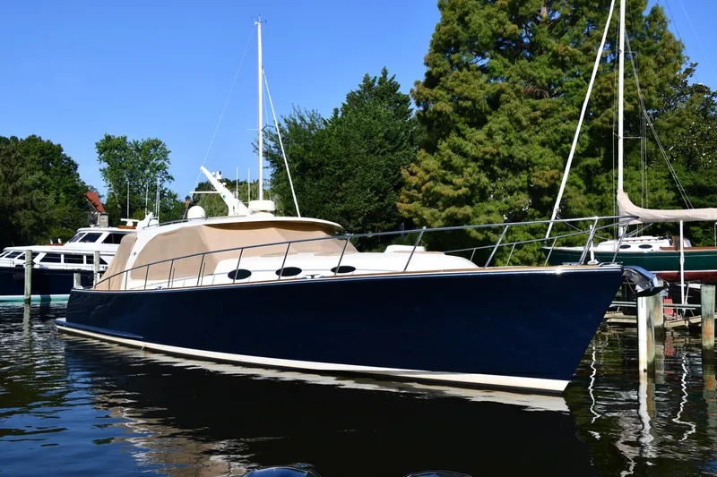 Mack Yacht Photos Pics 2020 Palm Beach Motor Yachts PB52 docked, sleek design, surrounded by trees and water.