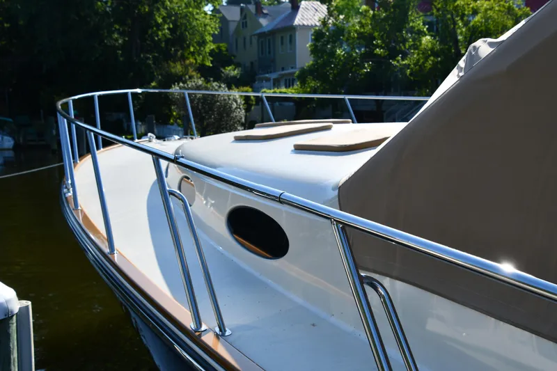 Mack Yacht Photos Pics 2020 Palm Beach Motor Yachts PB52, sleek design, docked near lush greenery.