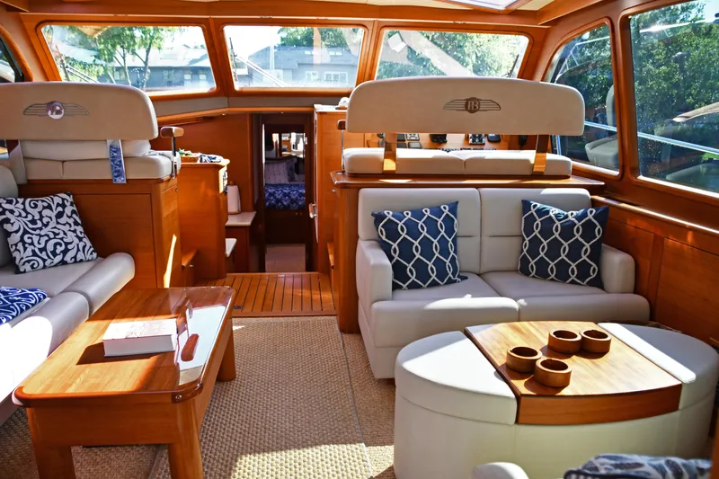 Mack Yacht Photos Pics Luxurious interior of 2020 Palm Beach Motor Yachts PB52 with elegant seating and wooden accents.