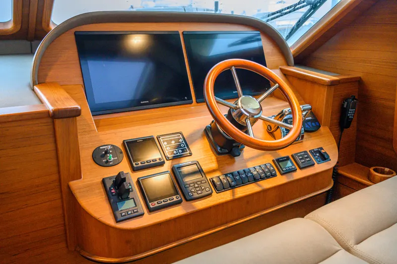 Mack Yacht Photos Pics Helm of 2020 Palm Beach Motor Yachts PB52 with wooden steering wheel and modern controls.