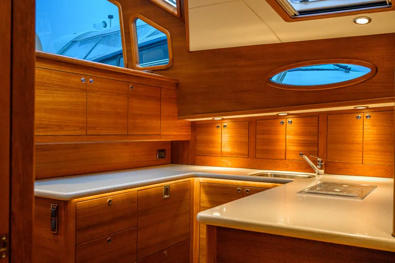 Mack Yacht Photos Pics Luxurious 2020 Palm Beach Motor Yachts PB52 interior with elegant wood cabinetry and modern fixtures.