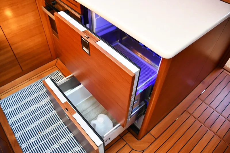 Mack Yacht Photos Pics 2020 Palm Beach Motor Yachts PB52 interior with open wooden drawers and modern design.