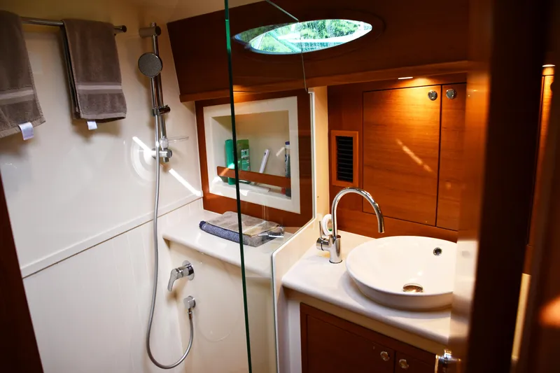 Mack Yacht Photos Pics Luxurious bathroom interior of 2020 Palm Beach Motor Yachts PB52, featuring modern fixtures and wood accents.