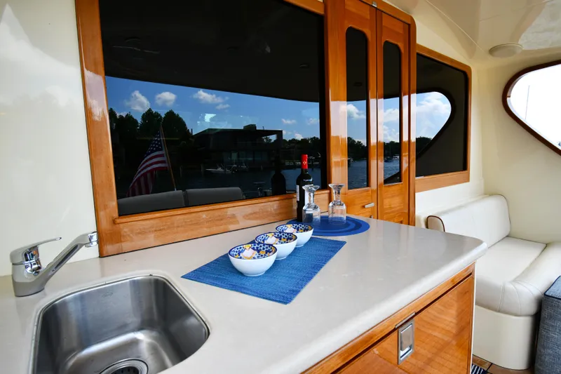 Mack Yacht Photos Pics Luxurious interior of 2020 Palm Beach Motor Yachts PB52 with elegant dining setup.