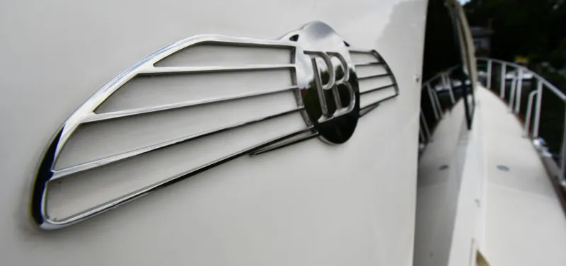 Mack Yacht Photos Pics 2020 Palm Beach Motor Yachts PB52 emblem on sleek white yacht exterior.