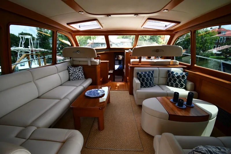 Mack Yacht Photos Pics Luxurious interior of 2020 Palm Beach Motor Yachts PB52, featuring elegant seating and wooden accents.