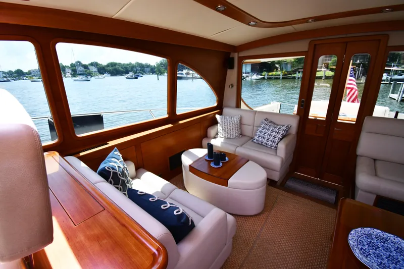 Mack Yacht Photos Pics Luxurious interior of 2020 Palm Beach Motor Yachts PB52 with elegant seating and scenic water view.