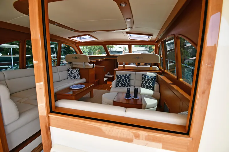 Mack Yacht Photos Pics Luxurious interior of 2020 Palm Beach Motor Yachts PB52, featuring elegant seating and wooden finishes.