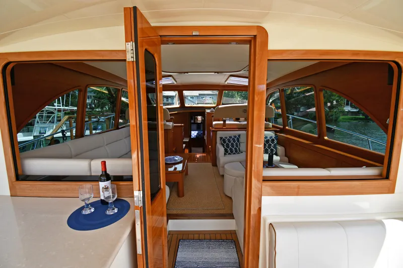 Mack Yacht Photos Pics Luxurious interior of 2020 Palm Beach Motor Yachts PB52, featuring elegant wood finishes and plush seating.