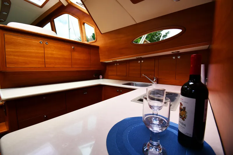 Mack Yacht Photos Pics Luxurious 2020 Palm Beach Motor Yachts PB52 interior with elegant wood cabinetry and wine setup.