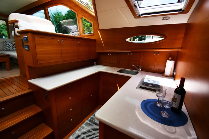 Mack Yacht Photos Pics Luxurious 2020 Palm Beach Motor Yachts PB52 interior with elegant wood cabinetry and modern amenities.