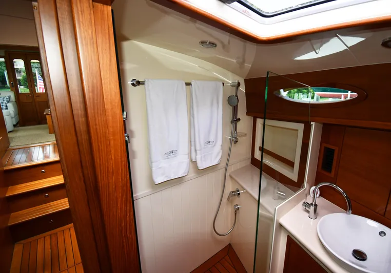 Mack Yacht Photos Pics Luxurious bathroom interior of 2020 Palm Beach Motor Yachts PB52, featuring wood accents and modern fixtures.