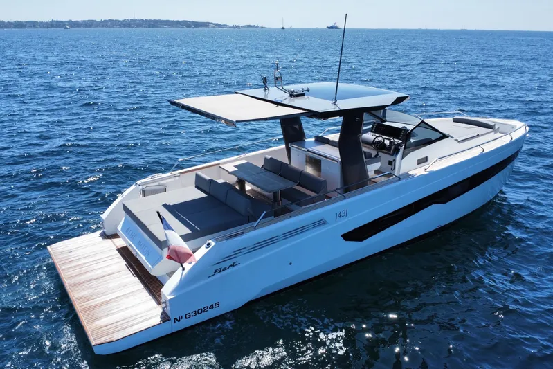 Blue Moon Yacht Photos Pics 2021 Fiart 43 yacht cruising on open sea, featuring sleek design and spacious deck.