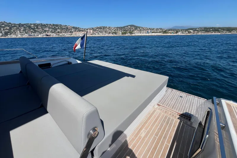 Blue Moon Yacht Photos Pics Luxurious 2021 Fiart 43 yacht with sun deck, cruising near scenic coastline.