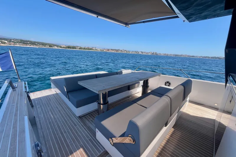 Blue Moon Yacht Photos Pics Luxury 2021 Fiart 43 yacht deck with seating, overlooking serene ocean view.