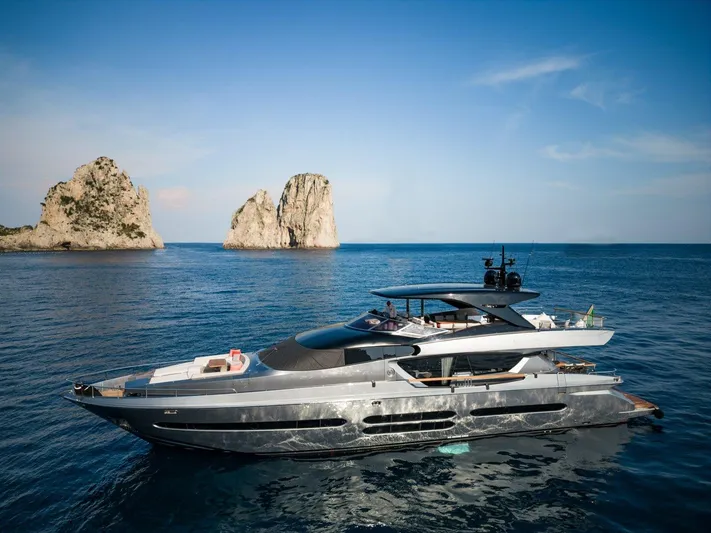  Yacht Photos Pics 2024 Posillipo Technema 90 luxury yacht cruising near rocky islands.