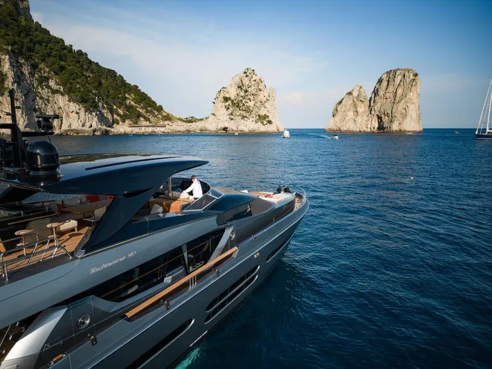  Yacht Photos Pics Luxury Posillipo Technema 90 yacht cruising near rocky coastline, 2024 model.